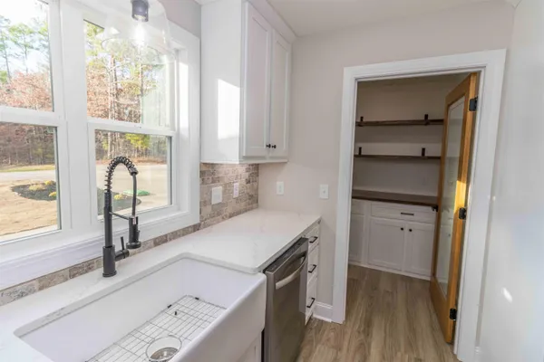 a kitchen with a refrigerator and a sink