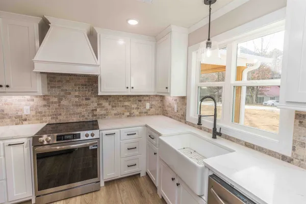 a kitchen with a sink stove and cabinets