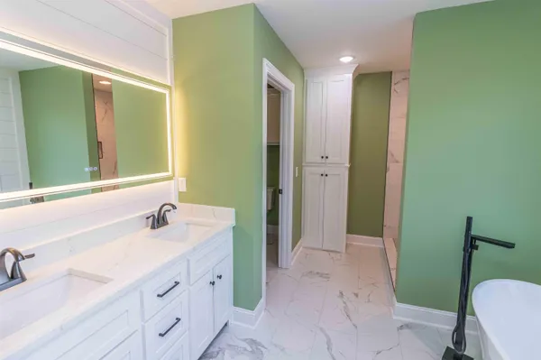 a bathroom with a double vanity sink and a mirror