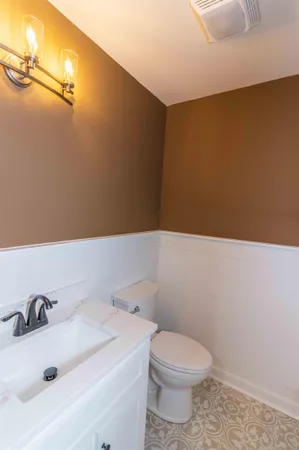 a bathroom with a sink a toilet and mirror