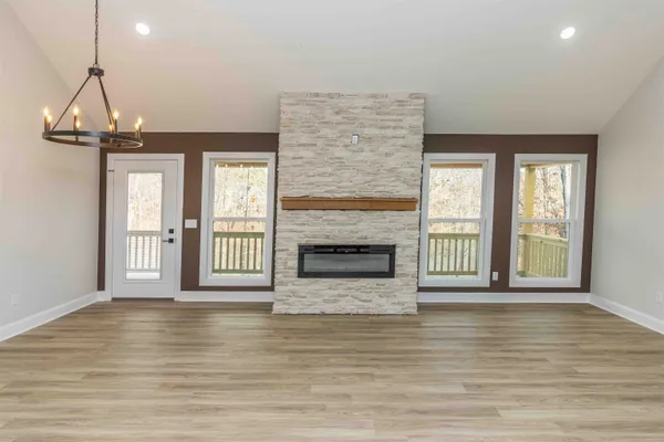 a view of a livingroom with a fireplace and window