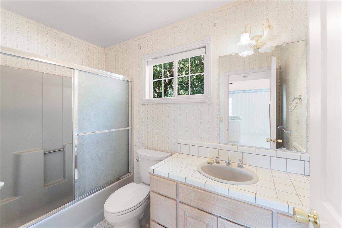 40101 Tassajara Road Carmel Valley, CA 93924 - Photo 22 of 91 a bathroom with a sink toilet vanity and shower
