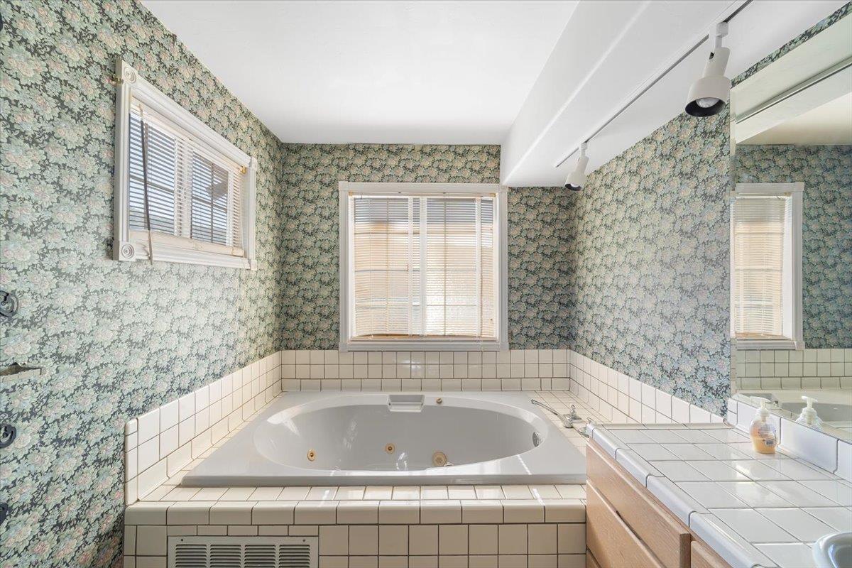 40101 Tassajara Road Carmel Valley, CA 93924 - Photo 32 of 91 a bath tub sitting in a bathroom next to a window