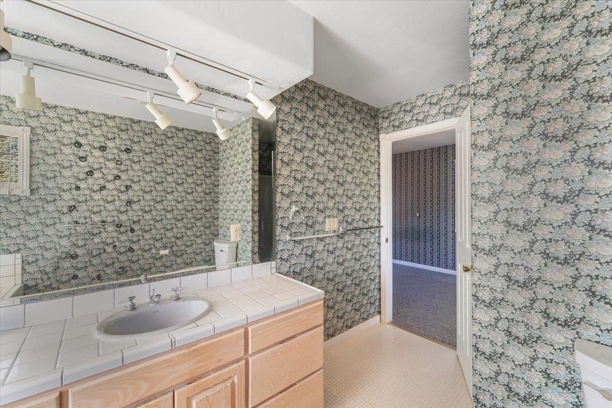 40101 Tassajara Road Carmel Valley, CA 93924 - Photo 33 of 91 a bathroom with a granite countertop shower and a sink