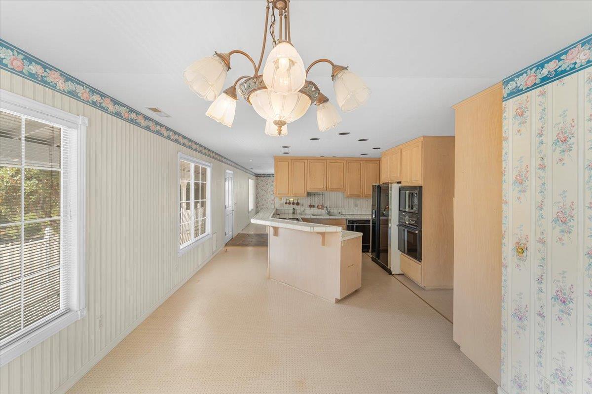 40101 Tassajara Road Carmel Valley, CA 93924 - Photo 54 of 91 a view of a kitchen with a refrigerator and microwave