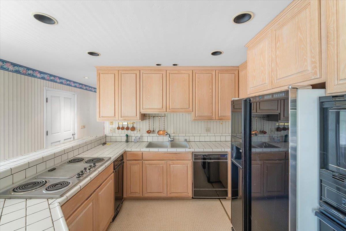 40101 Tassajara Road Carmel Valley, CA 93924 - Photo 56 of 91 a kitchen with a sink stove and refrigerator