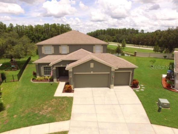 a aerial view of a house with big yard