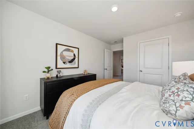 a bedroom with a bed and a dresser