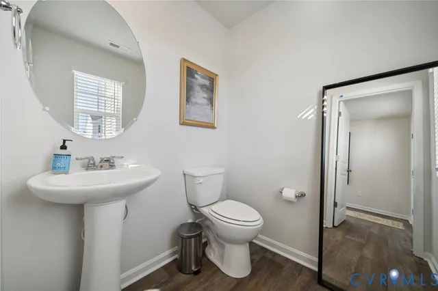 a bathroom with a sink toilet and a mirror