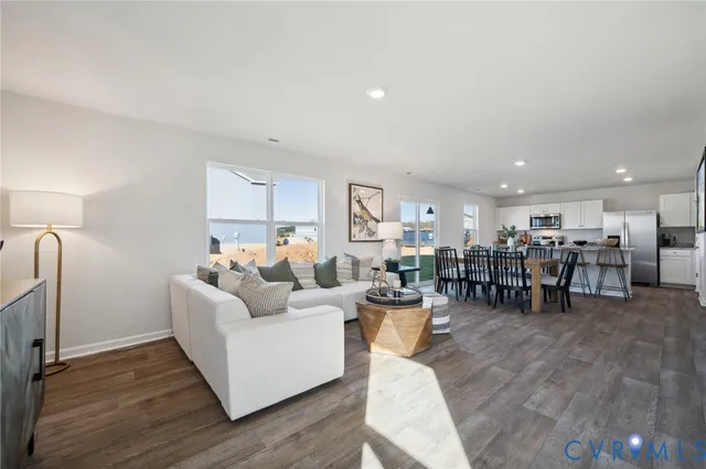 a living room with furniture and kitchen view