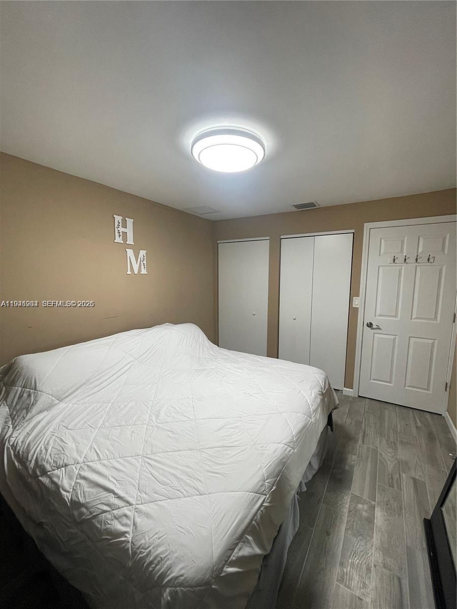 2730 Adams Street Hollywood, FL 33020 - Photo 7 of 8 a bedroom with a bed and a night stand