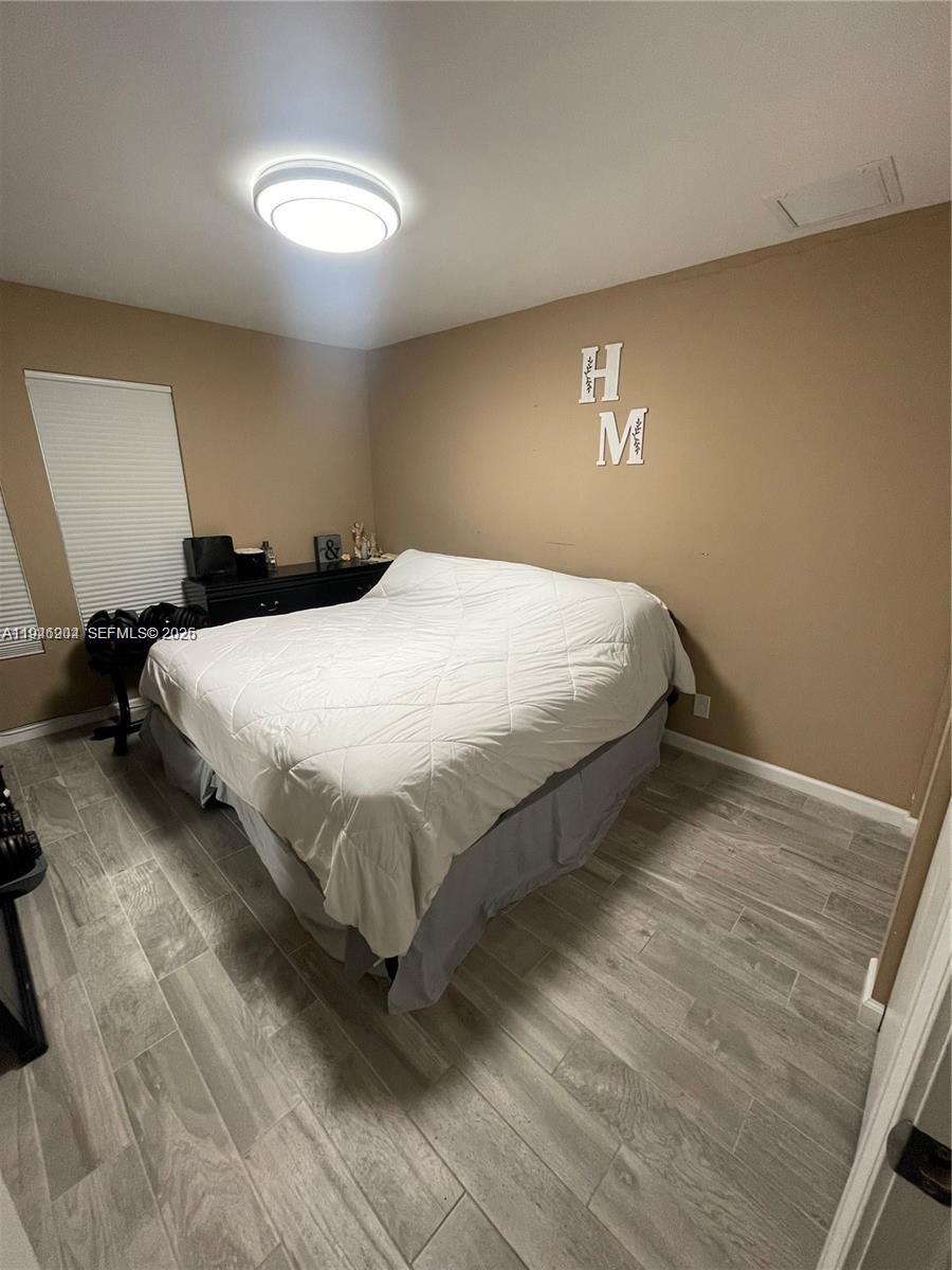 2730 Adams Street Hollywood, FL 33020 - Photo 8 of 8 a bedroom with a bed and a lamp