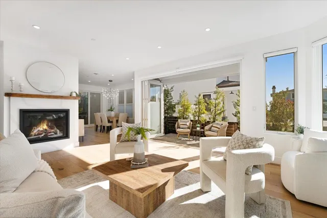 a view of a patio with couches table and chairs and potted plants