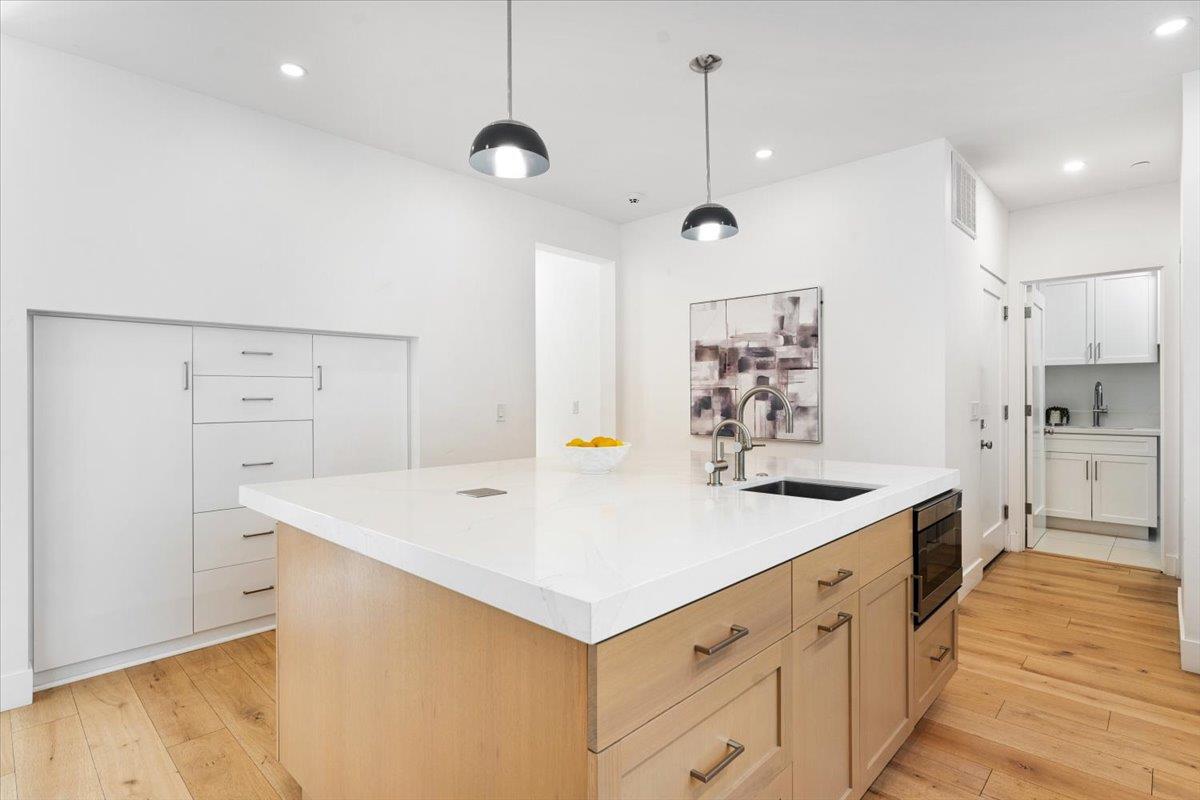 100 Bay Crest Road Santa Cruz, CA 95062 - Photo 26 of 62 a kitchen with a stove a refrigerator a sink and white cabinets with wooden floor