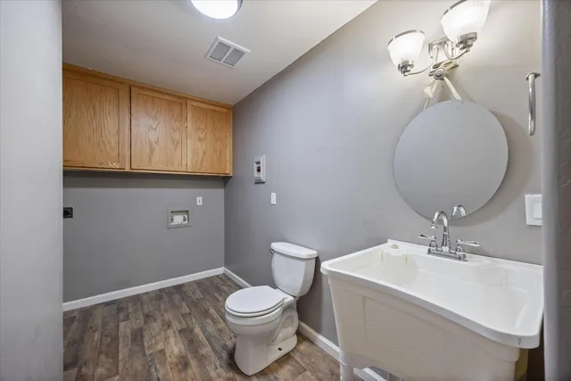 a bathroom with a toilet a sink and mirror