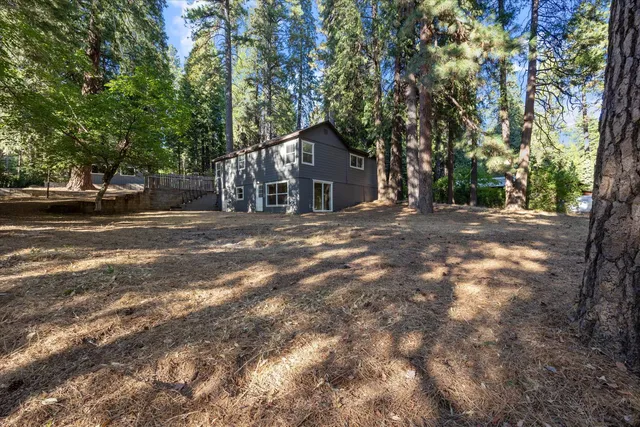 a view of a house with a tree in front of it