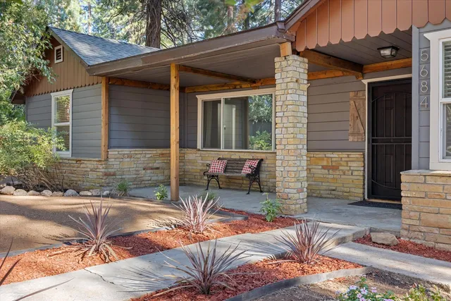 a view of house with backyard and outdoor seating