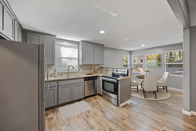 a kitchen with sink cabinets and wooden floor