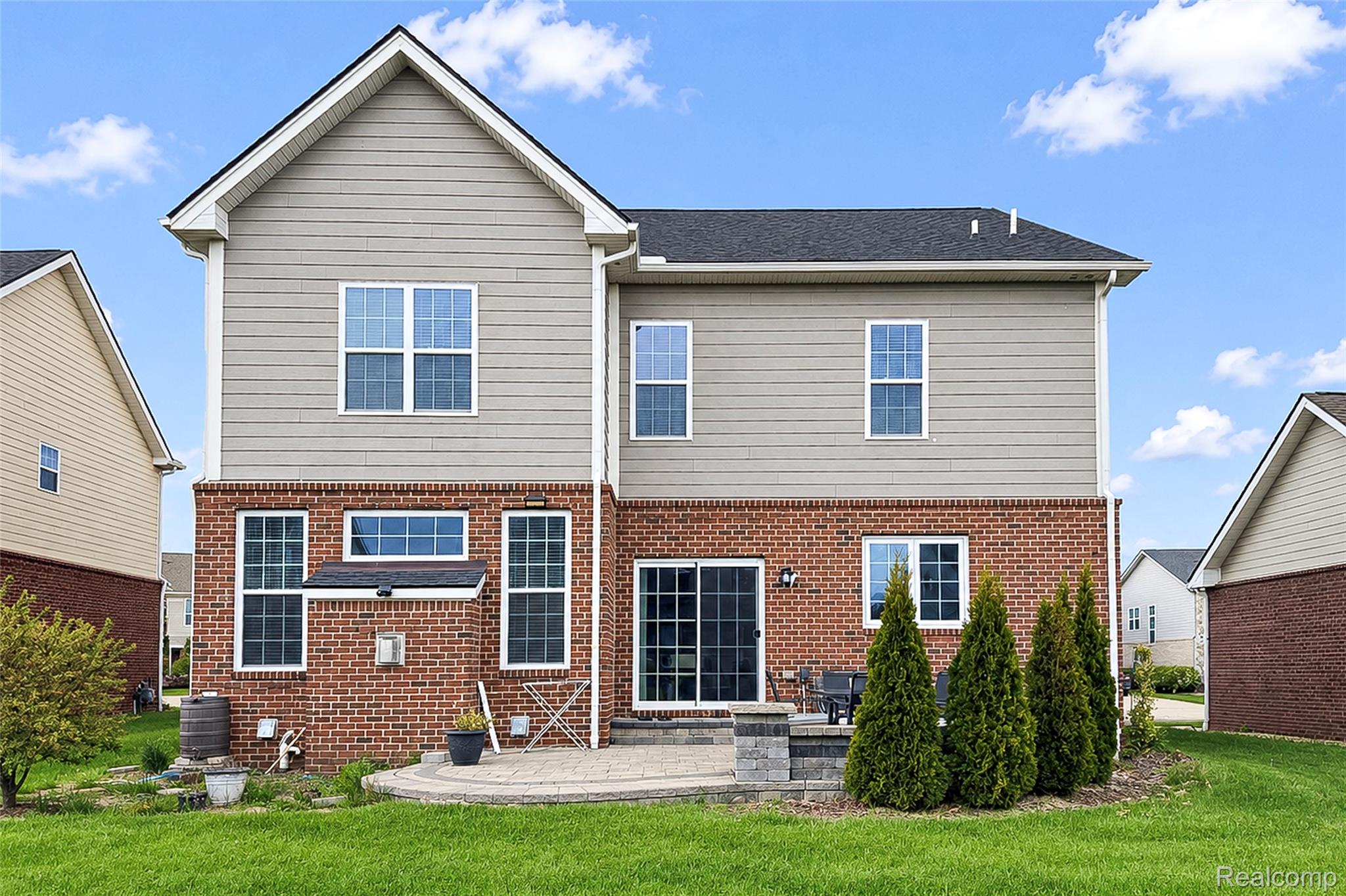 51011 Rockingham Drive Canton, MI 48188 - Photo 67 of 74 Rear view of property with a lawn, a patio, and brick siding