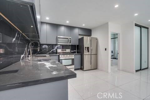 5032 Amestoy Encino, CA 91316 - Photo 12 of 22 a kitchen with stainless steel appliances granite countertop a refrigerator a stove and a sink