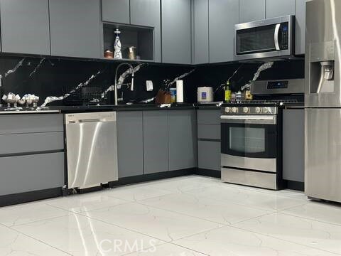 5032 Amestoy Encino, CA 91316 - Photo 16 of 22 a kitchen with stainless steel appliances granite countertop a stove and a microwave