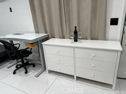 a view of a room with a table and chairs