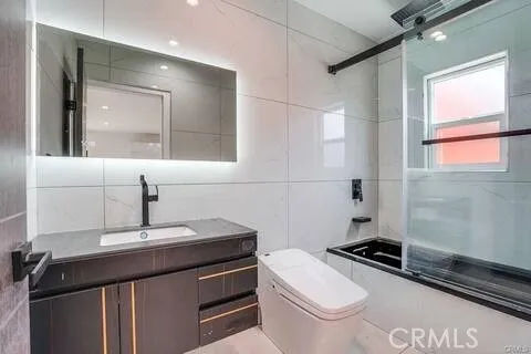 a bathroom with a sink a toilet a mirror and vanity