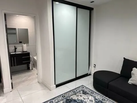 a living room with furniture and a mirror