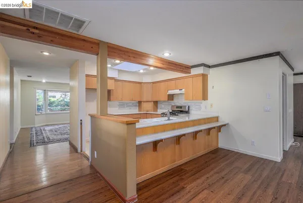 a kitchen with kitchen island a sink and wooden floor
