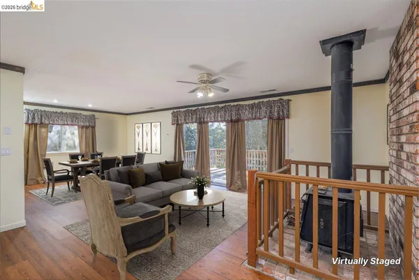 a living room with furniture and a floor to ceiling window