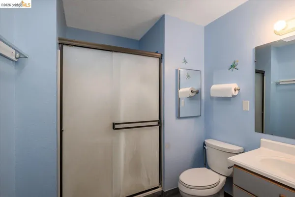 a white toilet sitting next to a bathroom sink