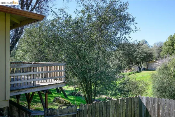 a view of a wooden bench in a backyard