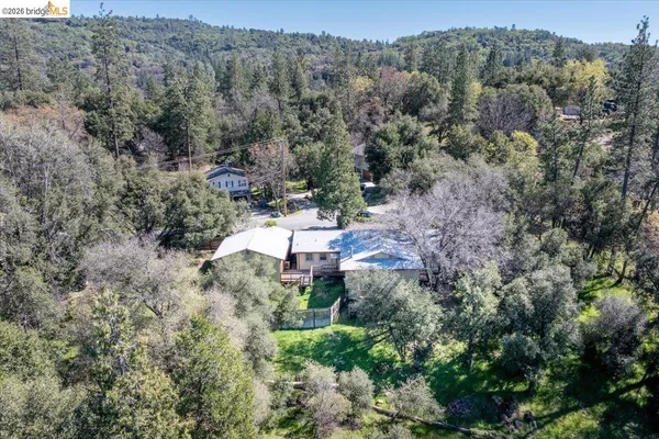 an aerial view of a house with a yard