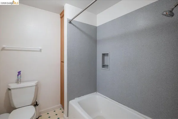 a white toilet sitting next to a bathroom sink