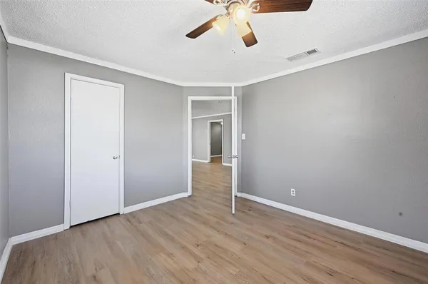 a view of an empty room with a ceiling fan