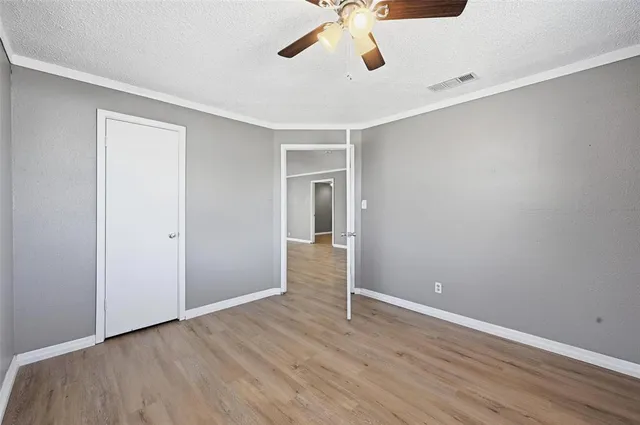 a view of an empty room with a ceiling fan