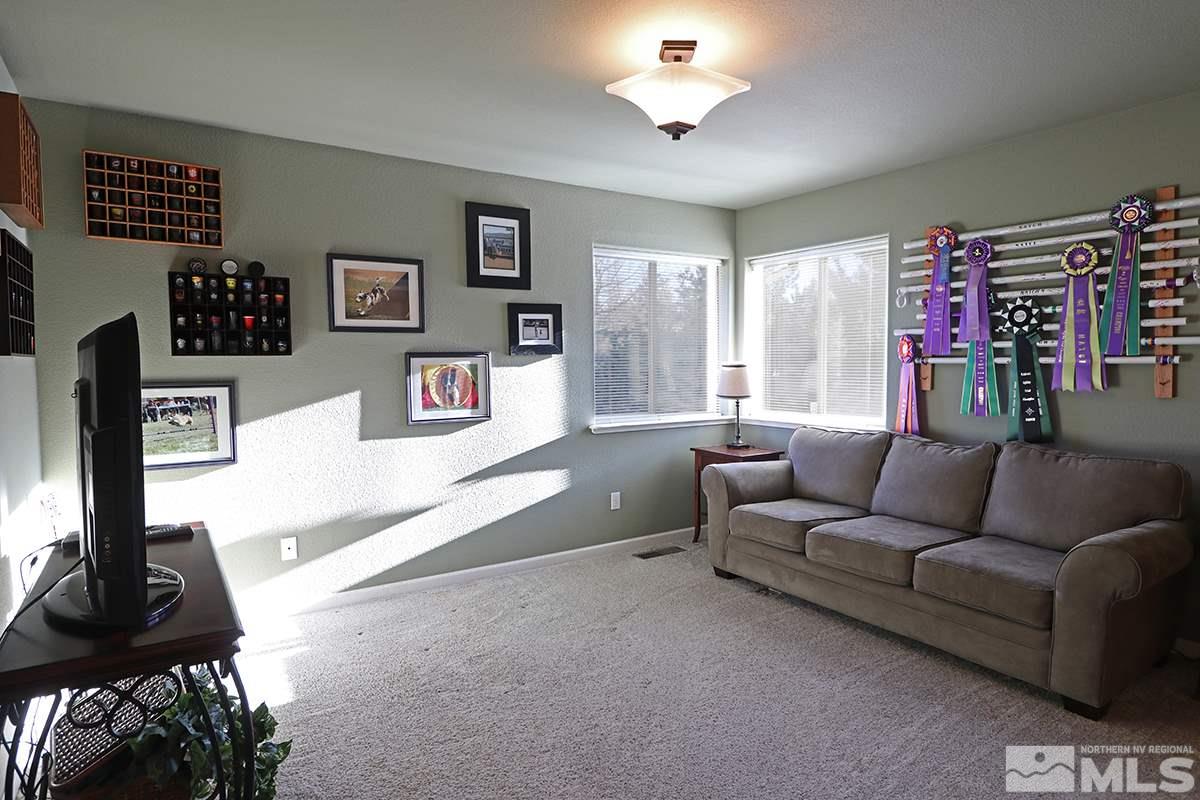 55 Water Lily Court Reno, NV 89511 - Photo 20 of 25 a living room with furniture a flat screen tv and a window
