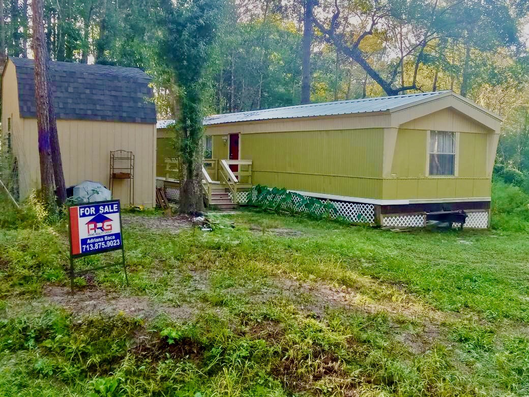 a view of a back yard of the house with a garden
