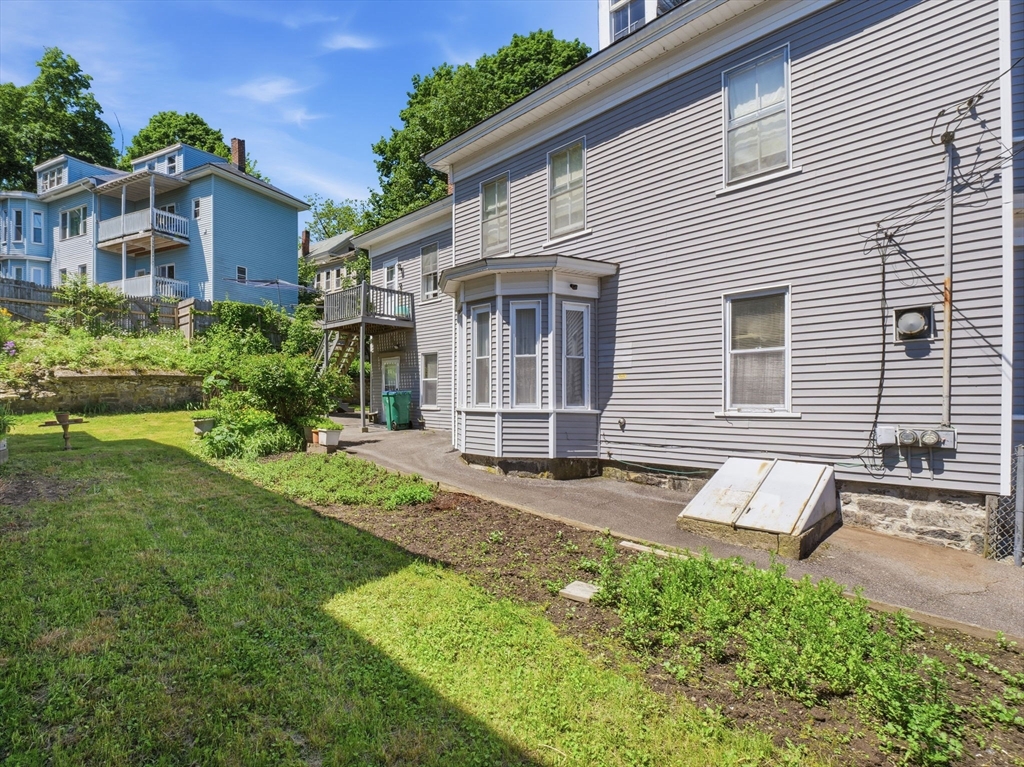 223 Stackpole Street Lowell, MA 01852 - Photo 36 of 42 a view of a house with backyard and plants