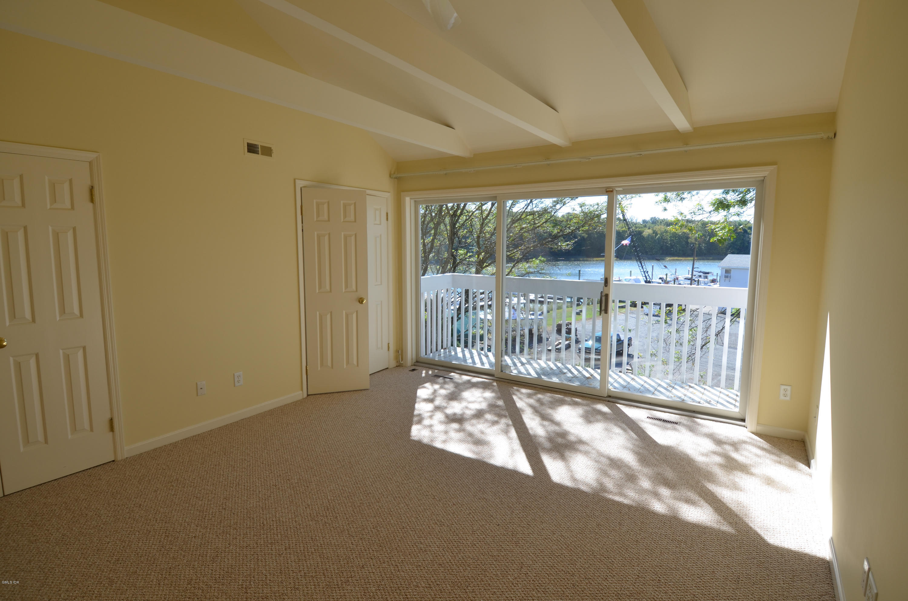 115 River Road, Unit 10 Cos Cob, CT 06807 - Photo 11 of 19 a view of empty room with wooden floor and a floor to ceiling window
