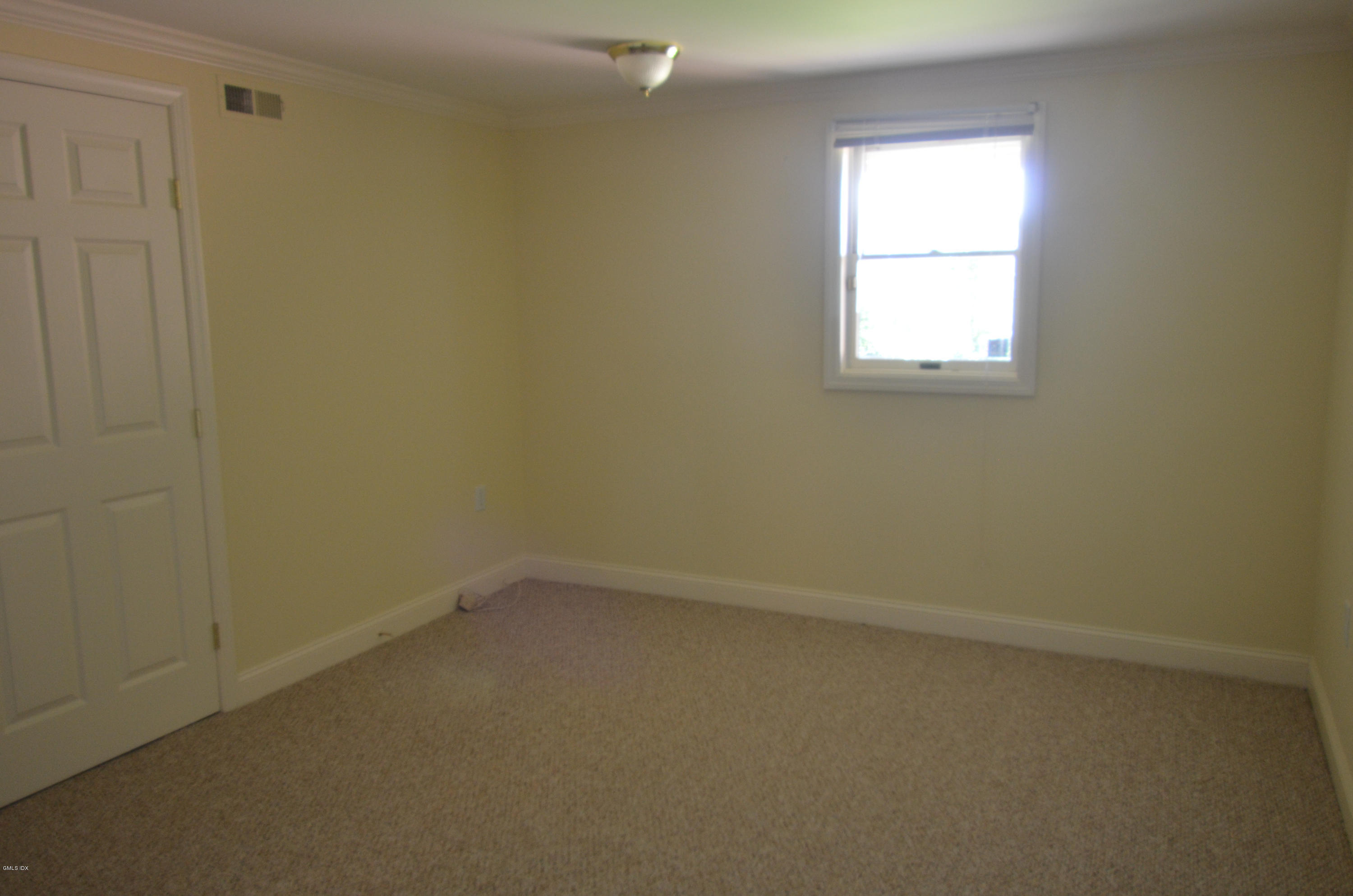 115 River Road, Unit 10 Cos Cob, CT 06807 - Photo 15 of 19 an empty room with a window