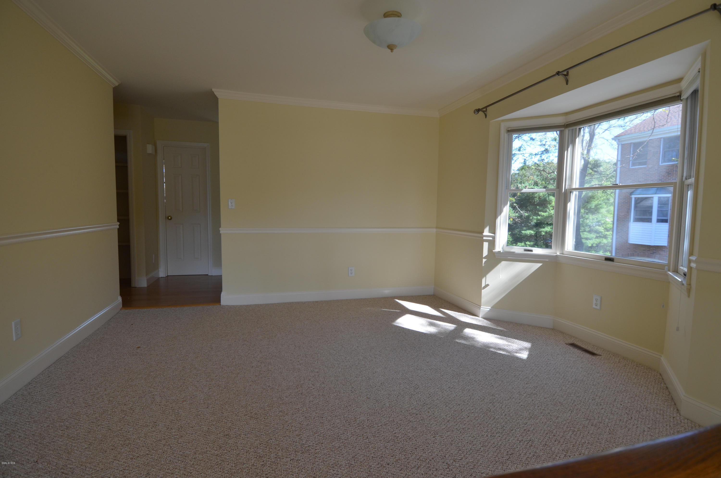 115 River Road, Unit 10 Cos Cob, CT 06807 - Photo 7 of 19 a view of an empty room with a window