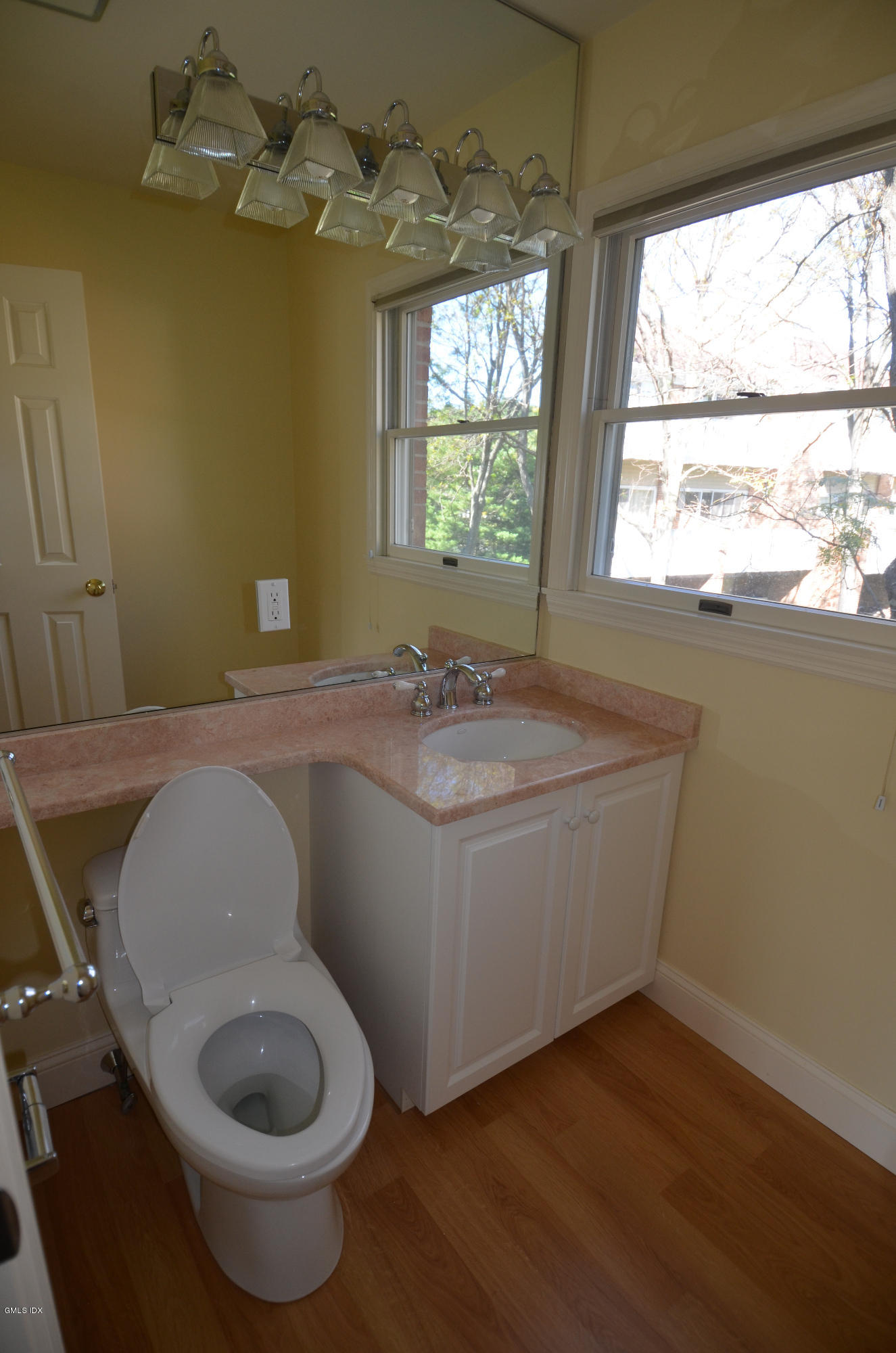 115 River Road, Unit 10 Cos Cob, CT 06807 - Photo 10 of 19 a bathroom with a toilet sink and window