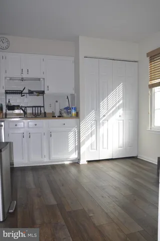 a view of a kitchen with wooden floor