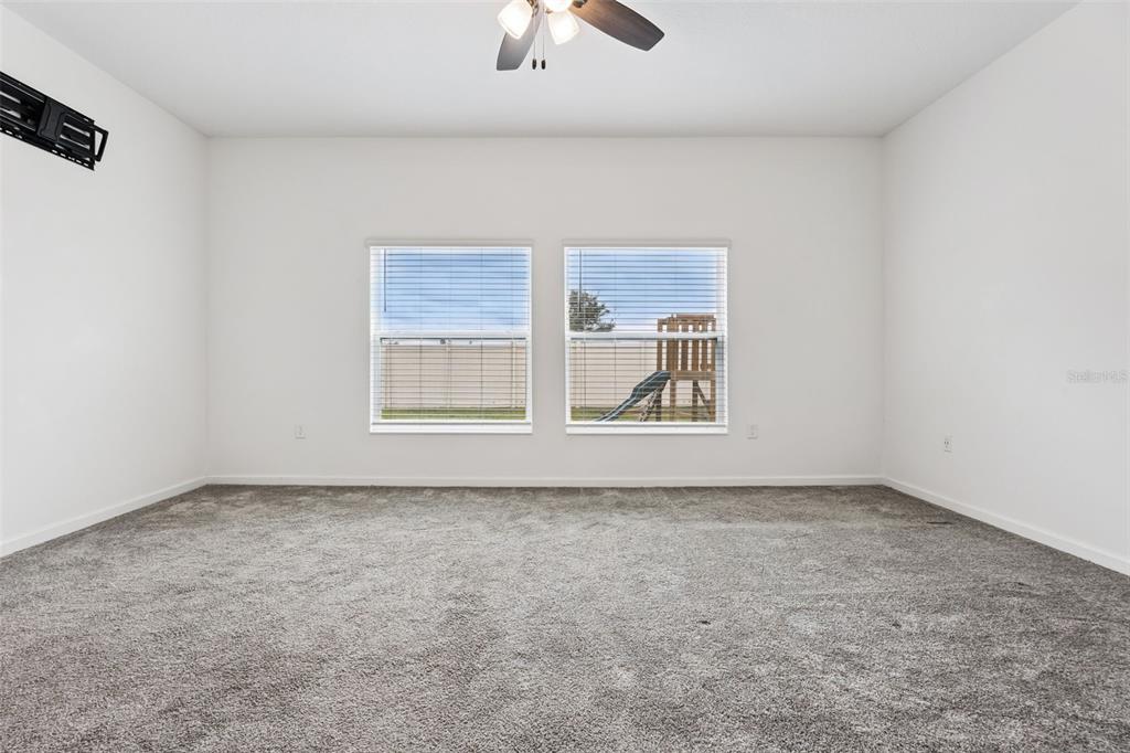 781 Taurus Lane St. Cloud, FL 34772 - Photo 11 of 36 an empty room with chandelier fan