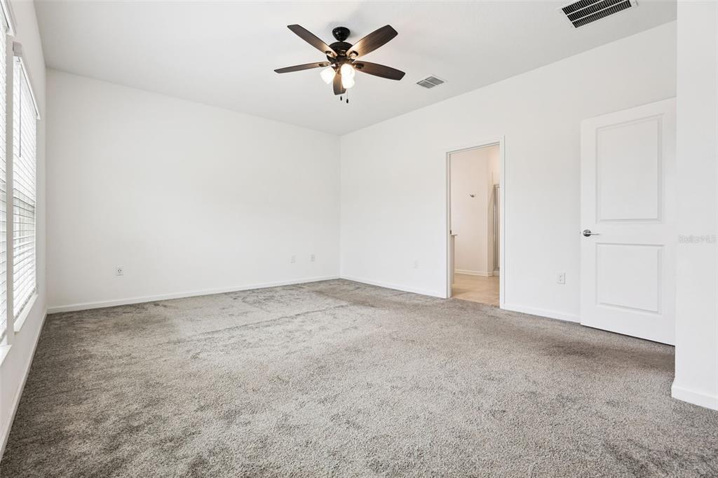 781 Taurus Lane St. Cloud, FL 34772 - Photo 13 of 36 an empty room with closet and a chandelier fan