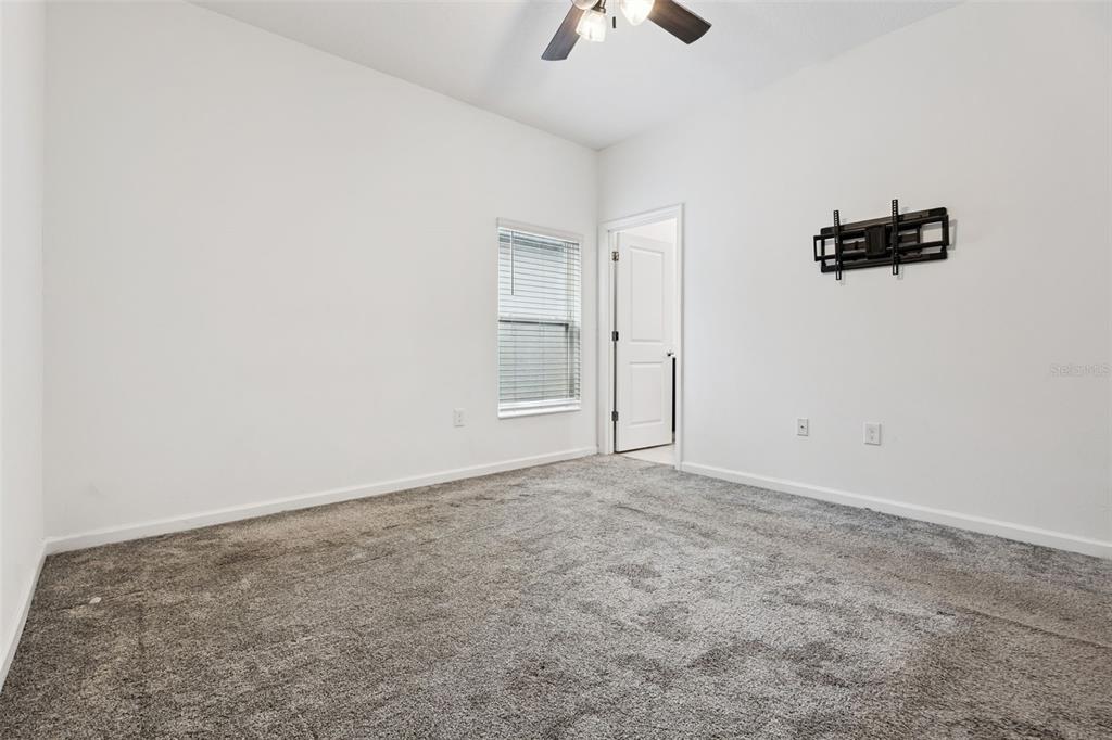 781 Taurus Lane St. Cloud, FL 34772 - Photo 15 of 36 an empty room with windows and fan