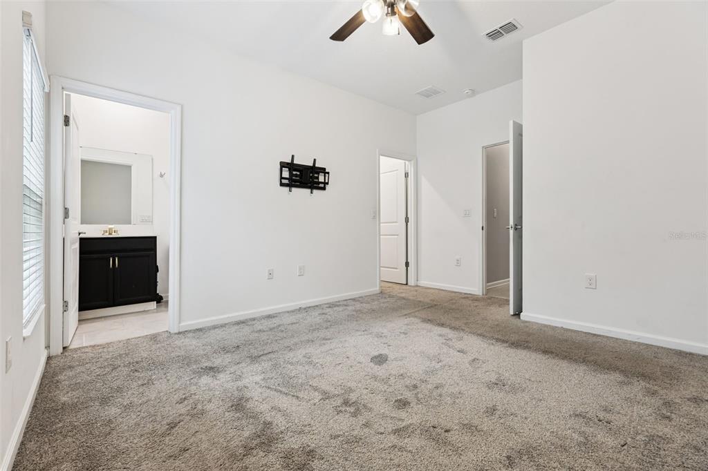 781 Taurus Lane St. Cloud, FL 34772 - Photo 17 of 36 an empty room with windows and cabinet