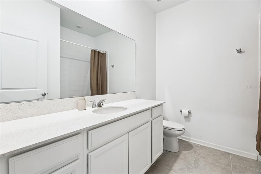 781 Taurus Lane St. Cloud, FL 34772 - Photo 23 of 36 a bathroom with a sink and a toilet
