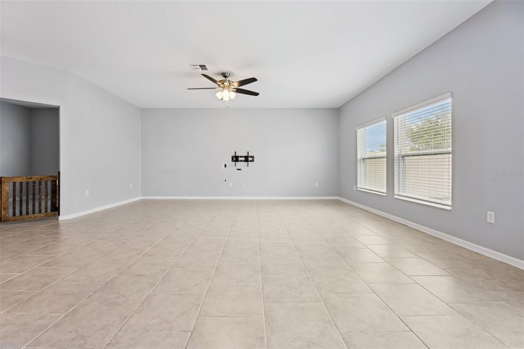781 Taurus Lane St. Cloud, FL 34772 - Photo 3 of 36 wooden floor in an empty room with a window
